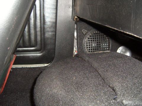 1973 Ford Ranchero - The photo shows the interior of a vehicle, focusing on the carpet and a speaker.
