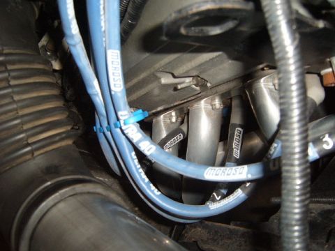 1973 Ford Ranchero - Close-up of engine components including blue Moroso spark plug wires and exhaust manifold.