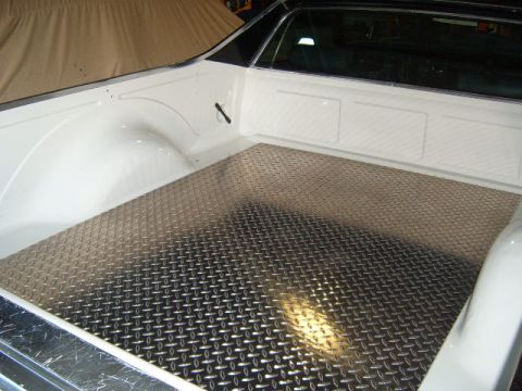 1973 Ford Ranchero - Diamond plate bed liner installed in the bed of a white pickup truck. The Supermotors.net logo is visible in the lower right corner.