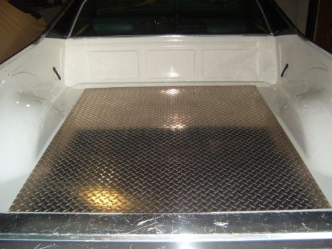 1973 Ford Ranchero - The rear of a vehicle shows a clean truck bed lined with diamond plate flooring.