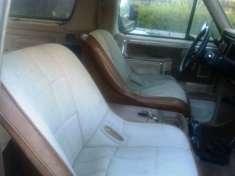 1986 Ford Bronco - Interior view of a vehicle's cabin, showing custom bucket seats and dashboard details.