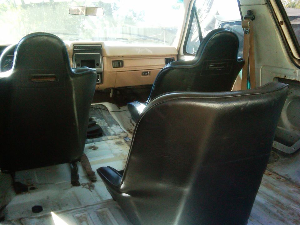 1986 Ford Bronco interior showing front bucket seats and dashboard