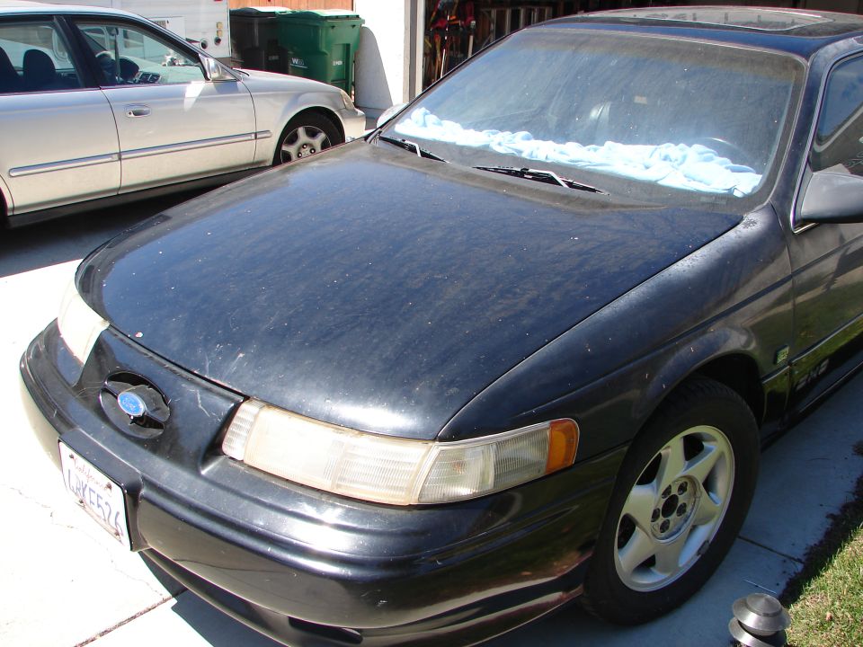 Dusty black 1992-95 Ford Taurus SHO sedan parked in a driveway
