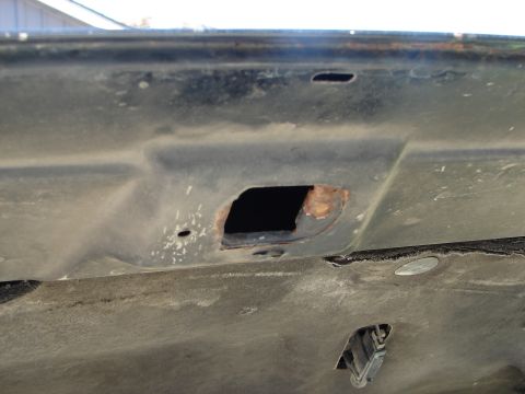 1992 Ford Taurus - Underside of a car hood with rust damage around a hole. Supermotors.net logo is visible.