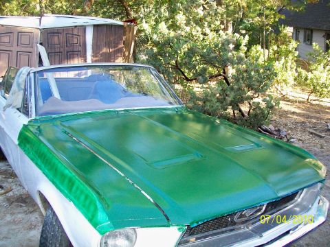 1968 Ford Mustang - A 1968 Ford Mustang convertible with a green hood is shown during a paint job.