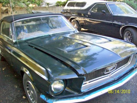 1968 Ford Mustang - Front view of a 1968 Ford Mustang convertible, with another vehicle behind it.