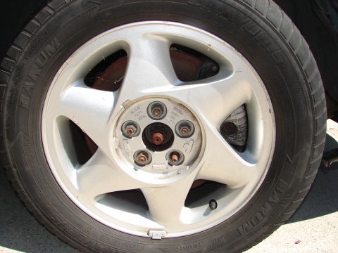 1992 Ford Taurus - Close-up of a vehicle's wheel and tire, with visible brake assembly.