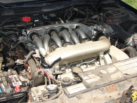 1992 Ford Taurus - Close-up of a Ford SHO 3.0L V6 engine, showing the intake manifold and timing belt area.