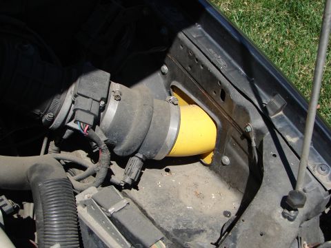 1992 Ford Taurus - Close-up view of a vehicle's engine bay, focusing on the air intake system and associated components.