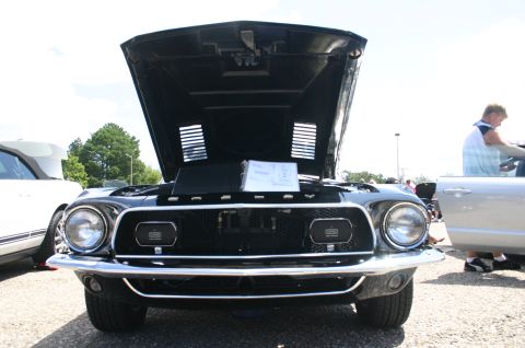 1968 Shelby GT500 - Front view of a black 1968 Shelby GT500 at a car show, hood raised.