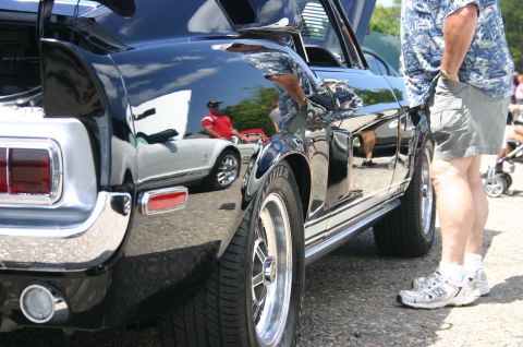 1968 Shelby GT500 - Rear view of a black 1968 Shelby GT500 at a car show, reflecting another vehicle.