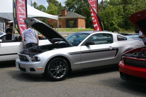 1968 Shelby GT500 - A silver Mustang is displayed with its hood open at an outdoor event, alongside other vehicles.