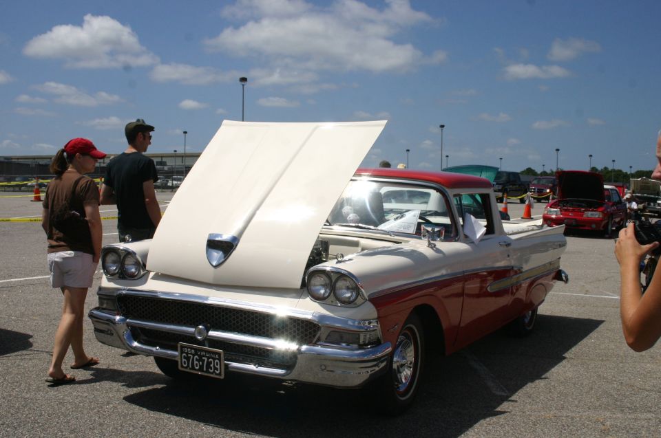 1957 Ford F-100 pickup truck, red and cream, front view, hood open