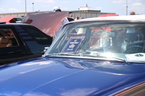 1968 Shelby GT500 - Award plaque on the dashboard of a blue car at a car show.