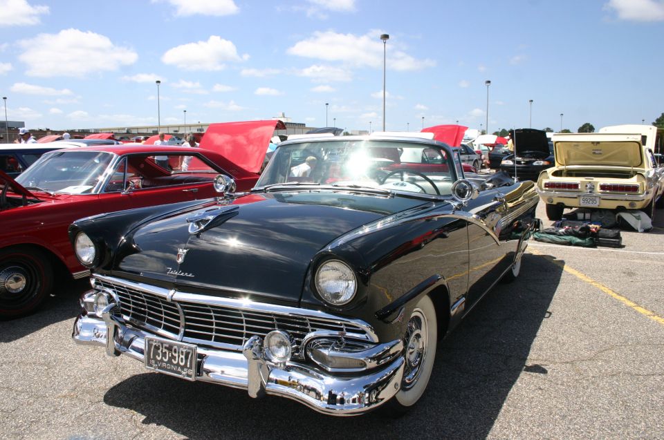 Black convertible with a white top, chrome grille, and a Virginia license plate reading 735-987