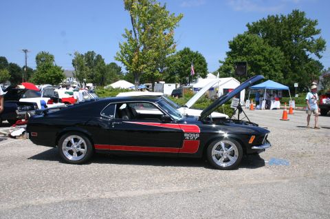 1968 Shelby GT500 - A black 1969 Ford Mustang Boss 427 is displayed with its hood open at an outdoor car show.