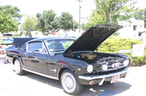 1968 Shelby GT500 - A black classic Ford Mustang is displayed with its hood open, revealing the engine bay.