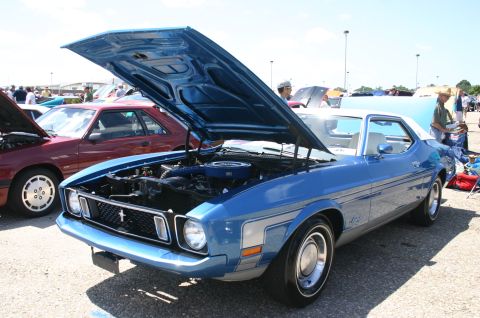 1968 Shelby GT500 - A blue and white 1971 Ford Mustang coupe is displayed with its hood open at an outdoor car show.