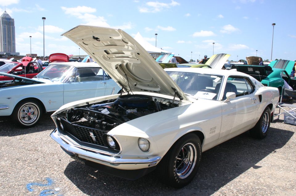White 1969 Ford Mustang Boss 429 with hood open, showing engine