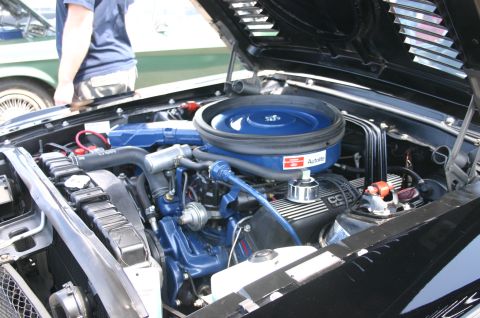 1968 Shelby GT500 - Engine bay details of a 1968 Shelby GT500, with a second vehicle partially visible behind it.