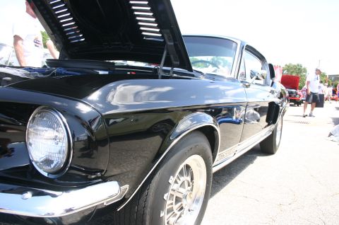 1968 Shelby GT500 - A black classic car, possibly a 1967 Shelby GT500, is displayed with its hood open at an outdoor event.