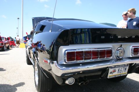1968 Shelby GT500 - A black 1968 Shelby GT500 is displayed at a car show, its distinctive taillights and Shelby badging.