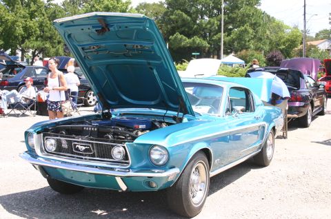 1968 Shelby GT500 - A blue 1967 Ford Mustang coupe is displayed with its hood open at an outdoor car show.