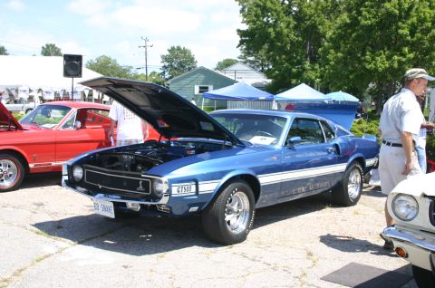 1968 Shelby GT500 - A blue 1969 Shelby GT500 is displayed with its hood open at an outdoor car show.