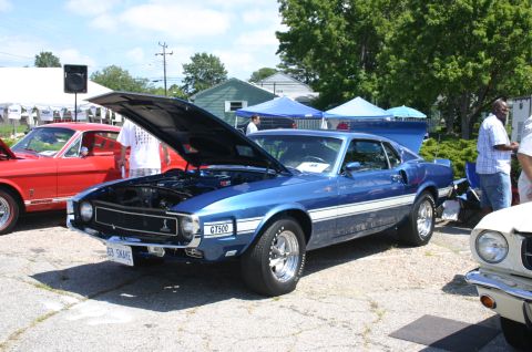 1968 Shelby GT500 - A blue 1969 Shelby GT500 is displayed with its hood open at an outdoor car show.