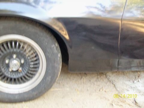 1972 Ford Ranchero - Side view of a car's fender and wheel, with a visible seam between body panels.