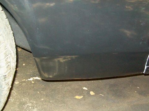 1972 Ford Ranchero - The lower rear fender and tire of a vehicle are shown, with some dust and debris on the ground.
