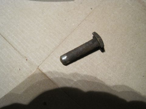 1979 Ford Bronco - A single rusty metal pin is shown against a textured background.