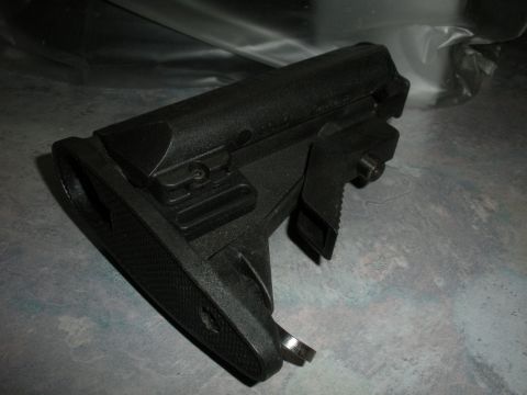 1996 Ford Bronco - A black adjustable gun stock is shown in detail, resting on a textured surface.
