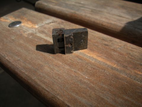 1996 Ford Bronco - A small metal component with visible spring action rests on weathered wooden planks.