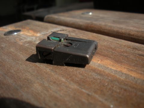 1996 Ford Bronco - A close-up of a gun sight rests on a weathered wooden surface.