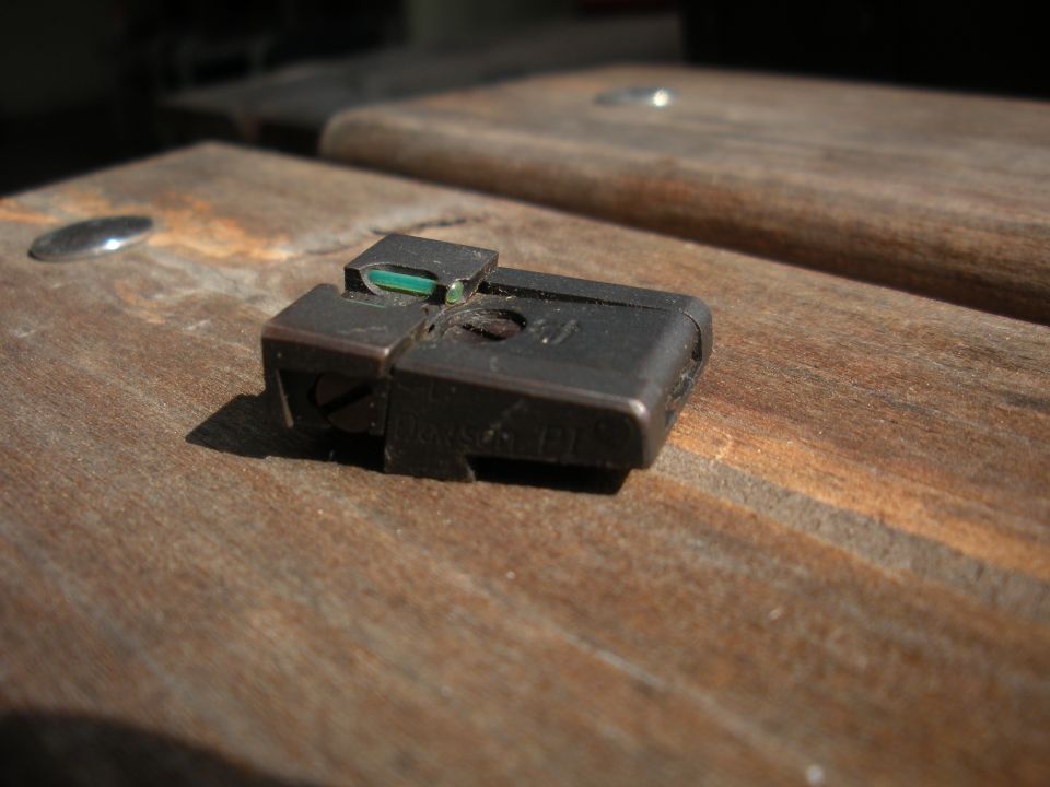 gun sight on wooden surface