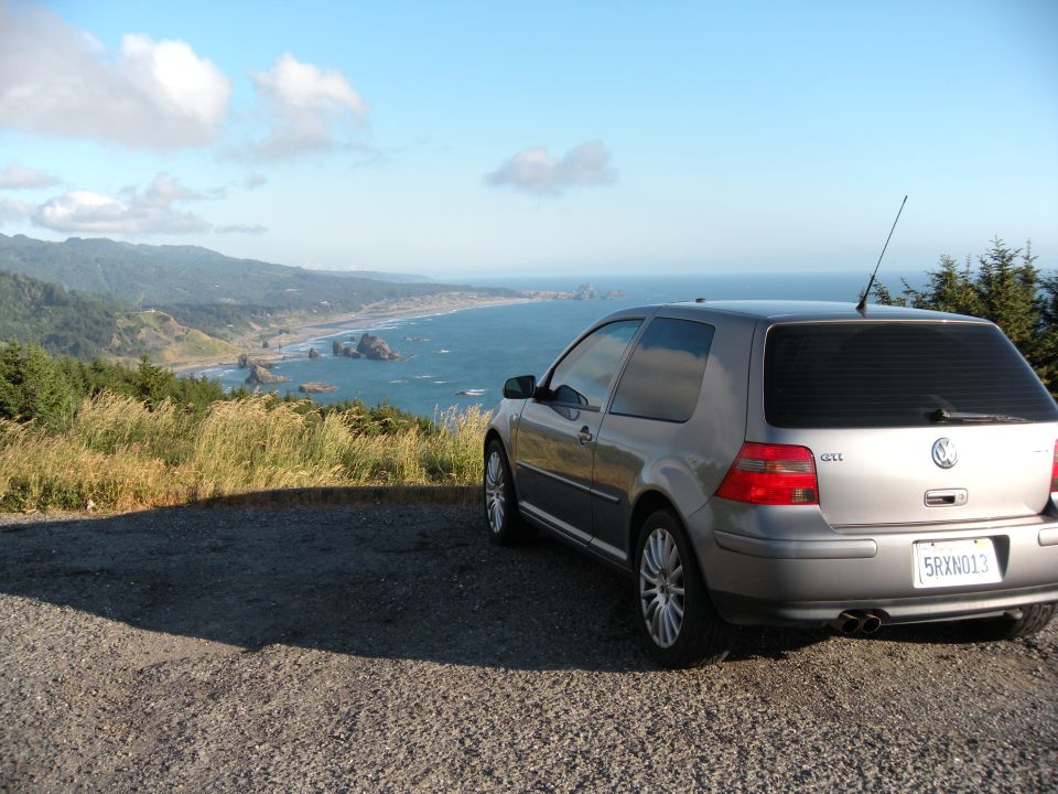 Silver Volkswagen GTI parked with ocean view. License plate 5RXN013