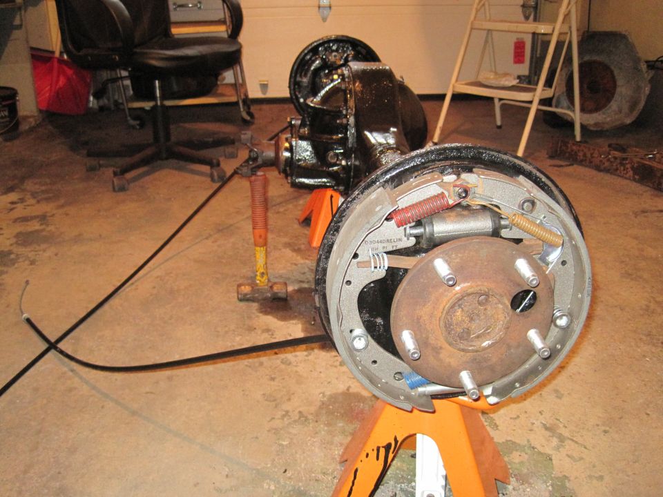 rear axle assembly on jack stands, showing brake drum and shoes