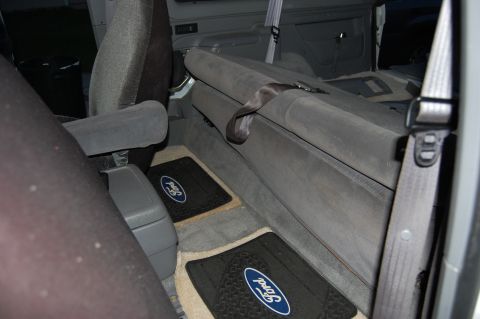 1994 Ford Bronco - Interior view of a vehicle with Ford-branded floor mats and grey upholstery.