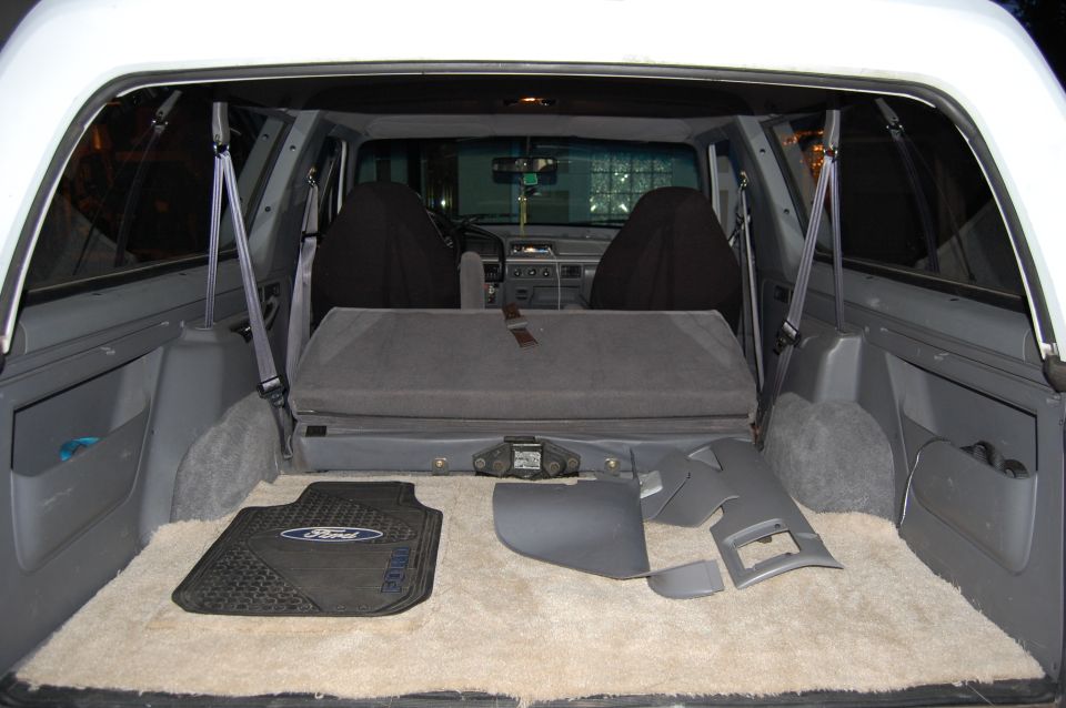 Interior cargo area of a 1994 Ford Bronco with folded rear seat and floor mats
