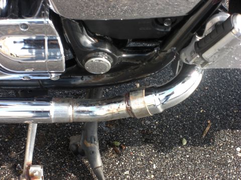 1986 Honda Shadow Aero - Close-up view of a motorcycle's chrome exhaust system.