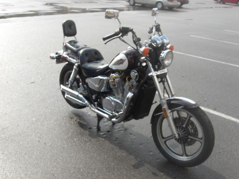 1986 Honda Shadow Aero - This 1986 Honda Shadow Aero motorcycle is shown from a three-quarter front perspective, highlighting its dark body and white tank detail.