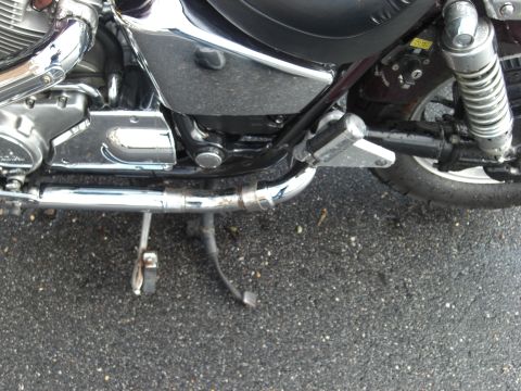 1986 Honda Shadow Aero - Detail view of a motorcycle's engine, exhaust, and rear shock absorber.