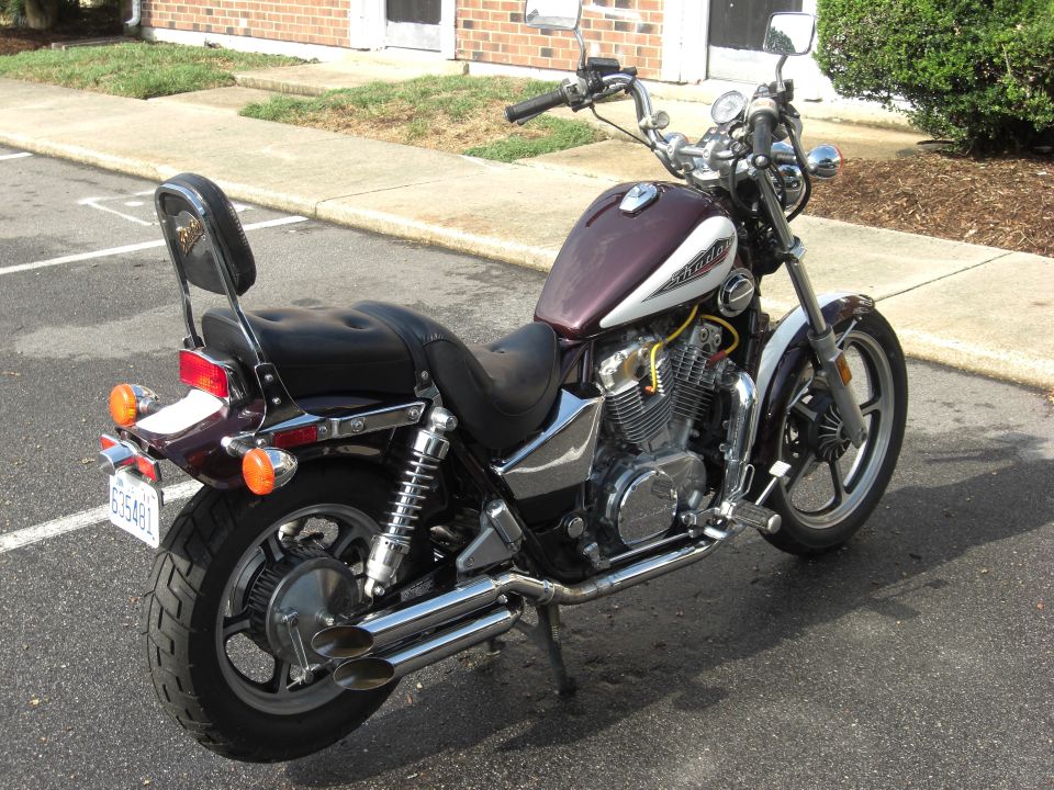 Maroon and silver Honda Shadow cruiser parked rear-left view in lot