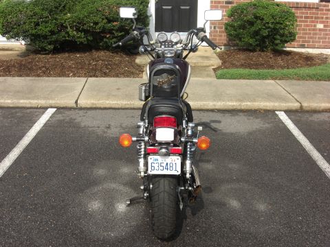 1986 Honda Shadow Aero - A motorcycle is parked in a lot, viewed from directly behind.
