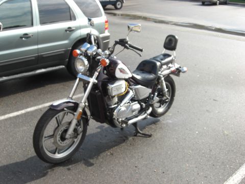 1986 Honda Shadow Aero - A parked motorcycle with a passenger backrest sits in a parking lot.