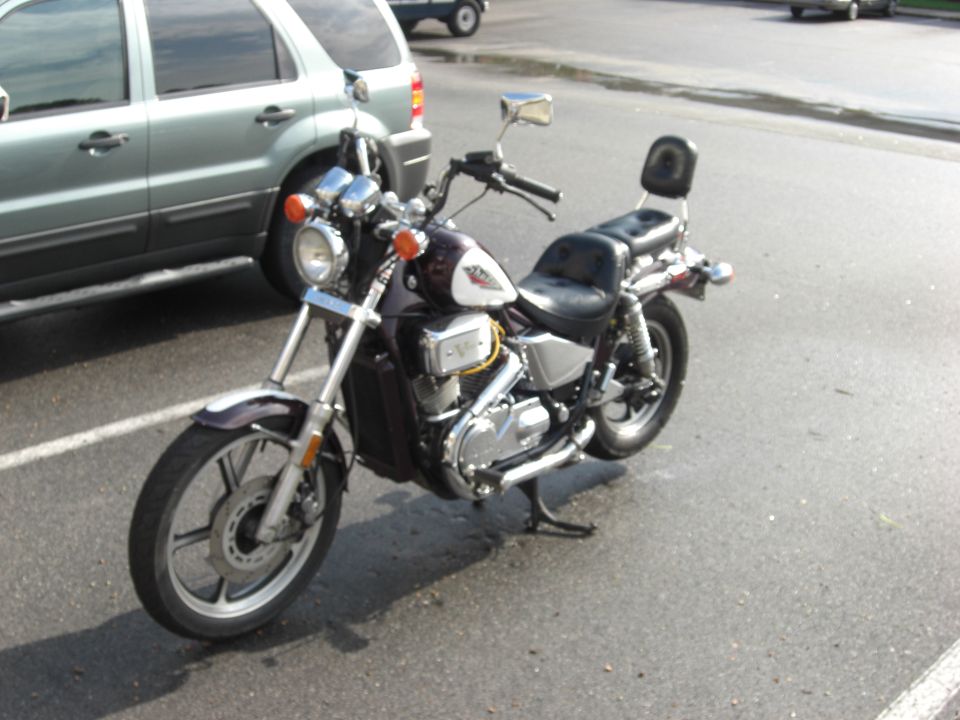Motorcycle parked next to a silver SUV