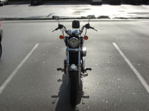 1986 Honda Shadow Aero - Front view of a 1986 Honda Shadow Aero motorcycle parked in a lot, showing its chrome details and orange turn signals.