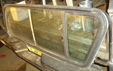1979 Ford Bronco - Rear quarter window assembly, likely from an older SUV or truck, showing its sliding vent mechanism.