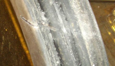 1979 Ford Bronco - A close-up view of a damaged tire tread, showing wear and a small crack. The Supermotors.net logo is visible in the corner.